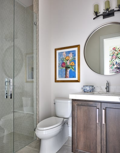 Bright bathroom with modern fixtures and vibrant art in a custom home in Charlotte, NC by Simonini Homes