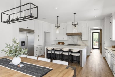 Custom kitchen with stainless steel appliances and marble backsplash by Simonini Homes in Mooresville, NC