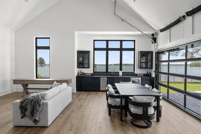 Lakeside living area with full-height windows and bar cabinetry in a Simonini Homes custom home, Mooresville, NC