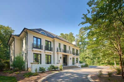 Luxurious front and side view of a Charlotte custom home featuring wrought iron balconies by Simonini Homes