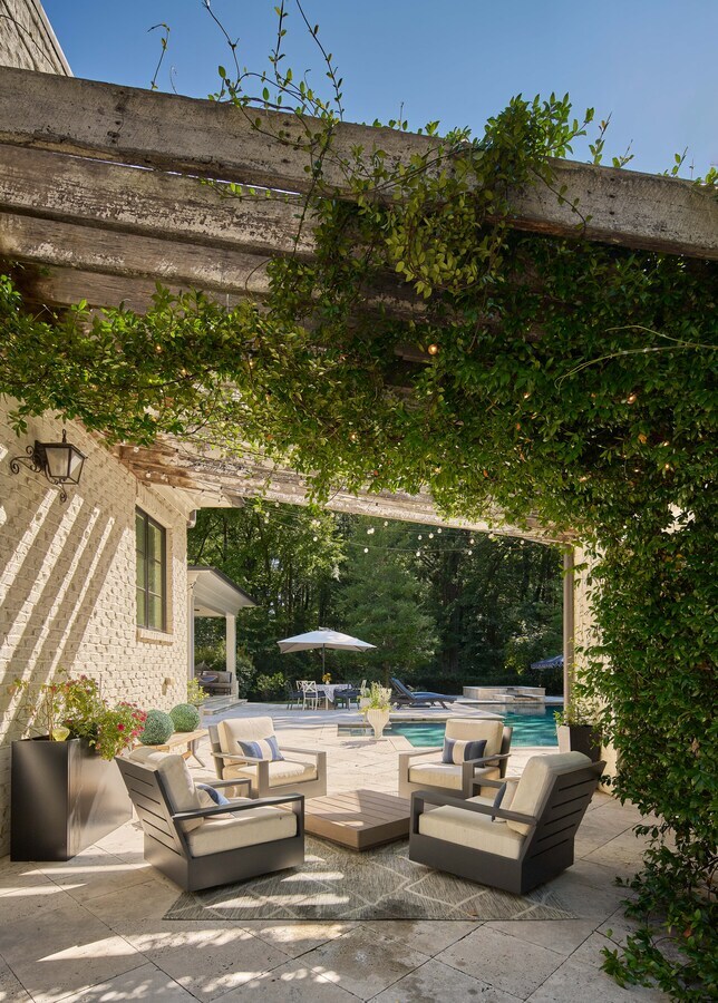 Vertical view of a pergola-covered patio leading to a luxury pool by Simonini Homes in Charlotte, NC
