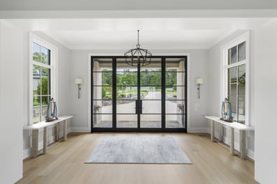 Bright entryway with wood floors in Mooresville custom home by Simonini Homes