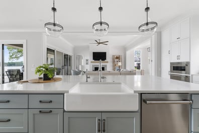 Clean kitchen design with quartz counters and pendant lights by Simonini Homes in Mooresville, NC