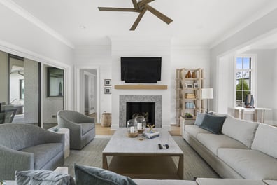 Cozy living area with TV above fireplace in Mooresville custom home by Simonini Homes