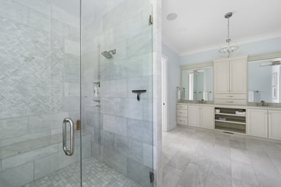 Frameless glass shower with tile inlay and double vanity by Simonini Homes in a custom Mooresville home