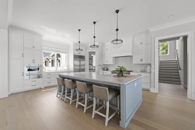 Light-filled kitchen with modern cabinetry and stainless appliances in Mooresville custom home by Simonini Homes