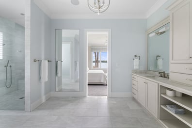 Open layout master bathroom with walk-in shower and lake view by Simonini Homes in Mooresville, NC