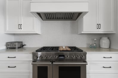 Stainless gas range and tile backsplash in custom Mooresville home by Simonini Homes