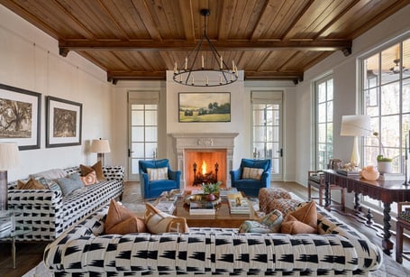 Bright living room with fireplace and patterned seating in a custom home in Eastover, Charlotte by Simonini Homes