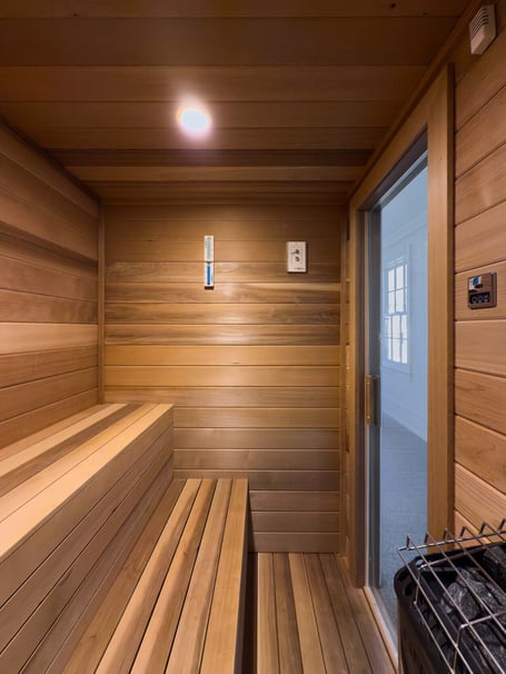 Compact home sauna with ergonomic bench layout in a custom home in Eastover, Charlotte by Simonini Homes