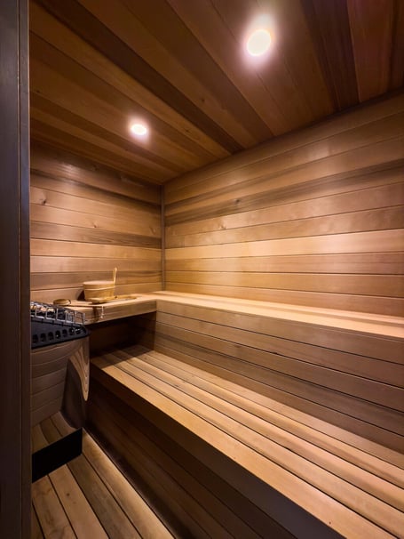 Custom wood-paneled sauna with built-in heater in a custom home in Eastover, Charlotte by Simonini Homes
