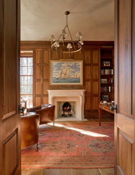 Grand view into formal study with fireplace and red rug in a custom home in Eastover, Charlotte by Simonini Homes