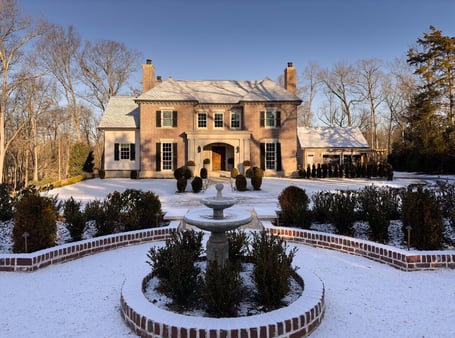 Snow-dusted landscape surrounding a stately custom home in Eastover, Charlotte by Simonini Homes