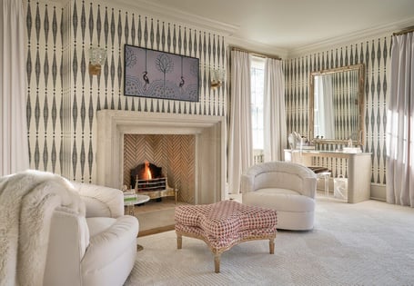 Sophisticated sitting room with patterned wallpaper and fireplace in a custom home in Eastover, Charlotte by Simonini Homes