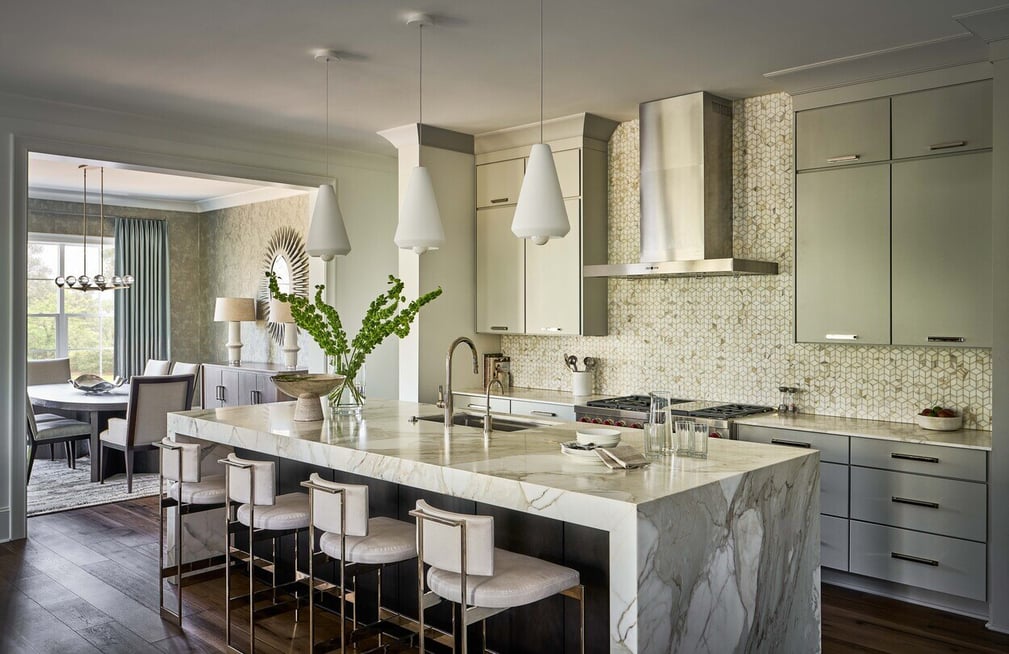 Modern luxury kitchen with a waterfall marble island and custom cabinetry by Simonini Homes in Charlotte, NC