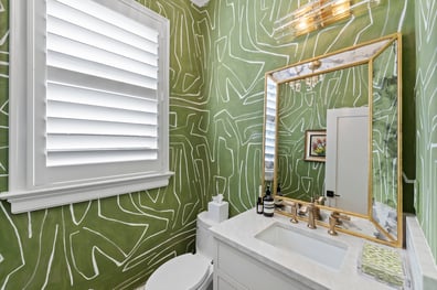 Bold powder room with green abstract wallpaper from a renovation in Ballantyne, NC