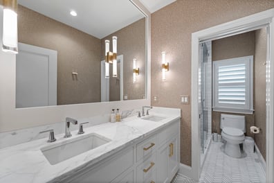 Elegant double-sink bathroom with marble counters from a renovation in Ballantyne, NC
