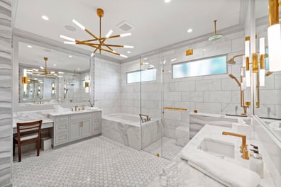 Elegant primary bathroom with double vanity and marble finishes from a renovation in Ballantyne, NC
