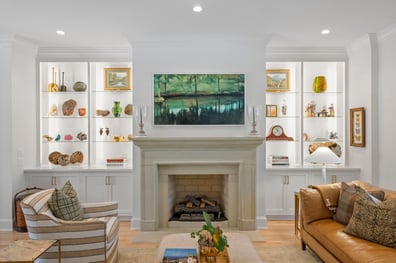 Fireplace wall with symmetrical built-ins and curated decor from a renovation in Ballantyne, NC