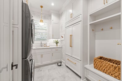 Laundry room with stacked appliances and white custom cabinetry from a renovation in Ballantyne, NC