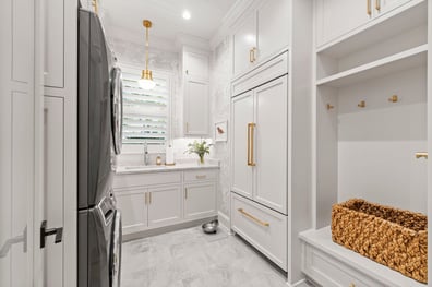 Laundry room with stacked appliances and white custom cabinetry from a renovation in Ballantyne, NC