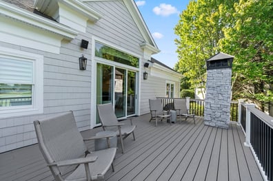 Spacious deck with seating and stone chimney from a renovation in Ballantyne, NC