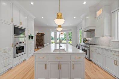 Spacious kitchen with oversized island and bay windows from a renovation in Ballantyne, NC