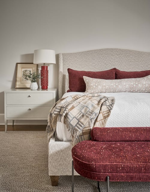 Close-up of custom bed and nightstand styling in Charlotte bedroom by Simonini Homes
