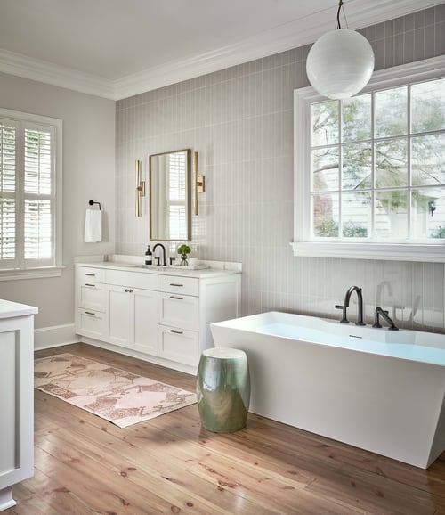 Freestanding bathtub and twin vanities in a Charlotte custom bathroom by Simonini Homes