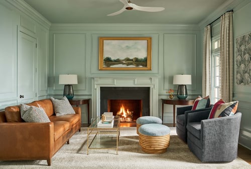 Neutral-toned lounge space with modern fireplace and blue accents in Charlotte custom home by Simonini Homes