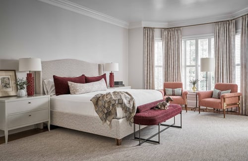 Primary bedroom in Charlotte custom home by Simonini Homes with burgundy and cream color palette