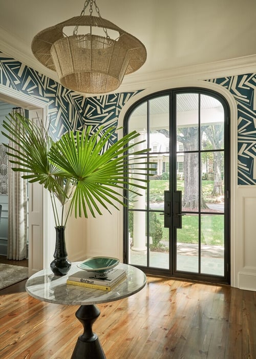 Simonini Homes creates stylish entryway in Charlotte custom home with vibrant wallpaper and view to exterior