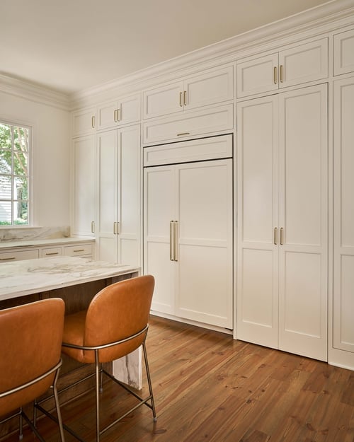 Simonini Homes custom kitchen in Charlotte, NC featuring concealed fridge and tall white cabinets