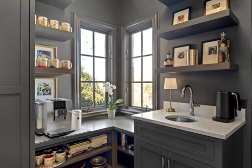 Built-in beverage station with modern espresso machine and display shelves in a Charlotte, NC custom home