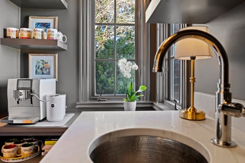 Close-up of wet bar sink and espresso station by a window in a custom home in Charlotte, NC