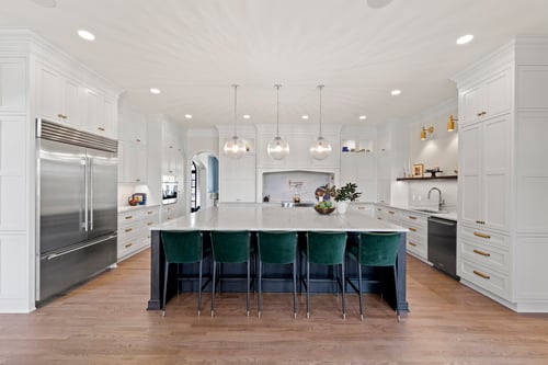 Kitchen island with dark wood base and marble top in a custom home in Charlotte, NC