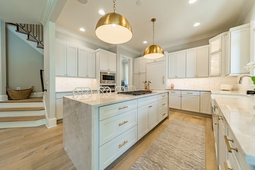 Gourmet kitchen with marble countertops and pendant lights in a custom home in Charlotte, NC