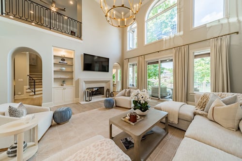 Grand living room with vaulted ceilings and arched windows in a custom home in Charlotte, NC