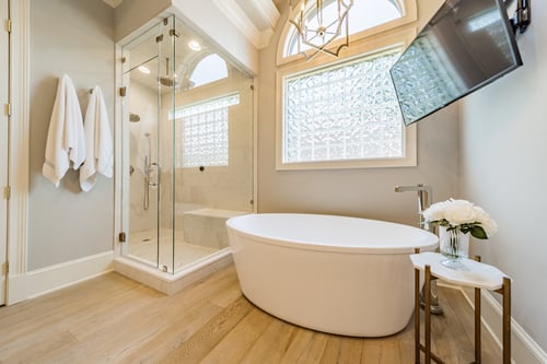 Luxury bathroom with frameless glass shower and modern soaking tub in a custom home in Charlotte, NC