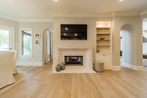 Neutral-toned fireplace and built-in shelving in a custom home in Charlotte, NC