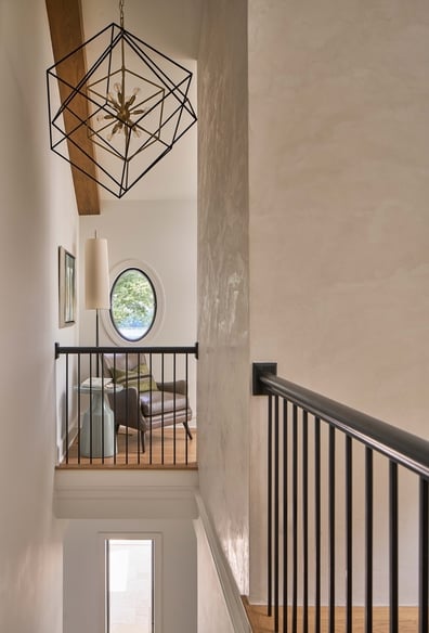 Modern hallway design with black railings in a Simonini Homes custom home in SouthPark, NC
