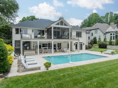 Poolside patio with loungers and hot tub in a custom build by Simonini Homes in Myers Park, NC