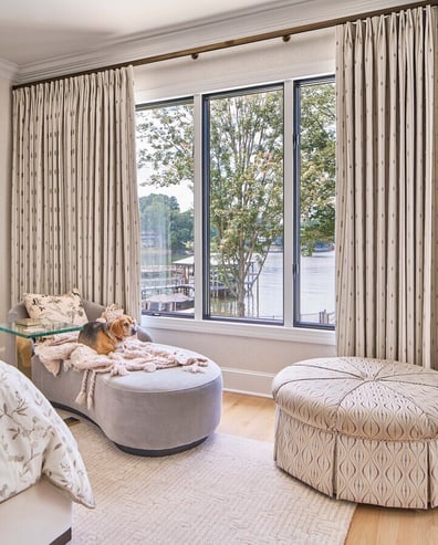Relaxing lounge chair by the window with water views in Simonini Homes Ballantyne project