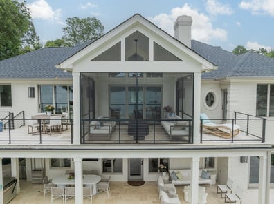 Two-story outdoor entertaining space with dining and lounging areas by Simonini Homes in Cornelius, NC