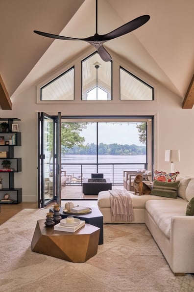 Vaulted ceiling living room opening to lakefront patio in Simonini Homes project in Davidson, NC