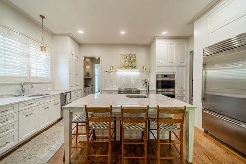 Bright kitchen remodel with large island and marble backsplash from a renovation in Charlotte, NC