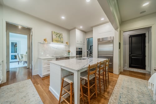 Bright kitchen with marble island and custom cabinetry from a renovation in Charlotte, NC
