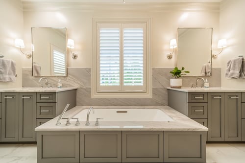Centered soaking tub flanked by vanities in a luxury bathroom renovation in Charlotte, NC