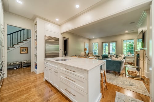 Renovated kitchen in Charlotte, NC showing custom cabinetry and connection to open living area