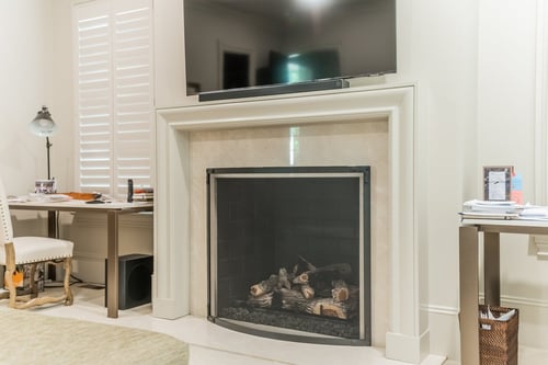 Renovated living space with white fireplace surround and modern tech in Charlotte, NC